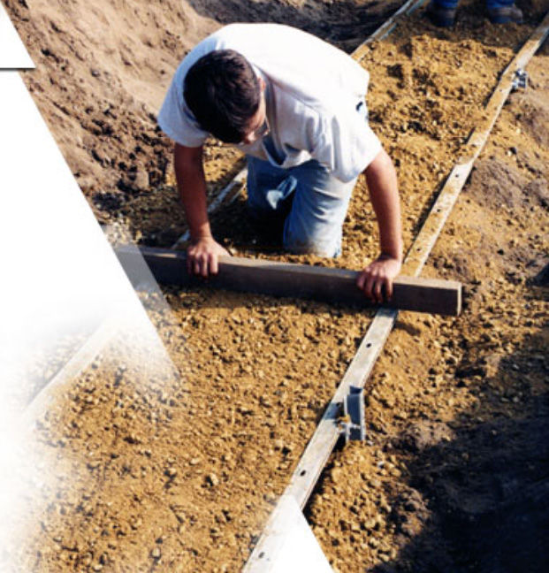 For long, fairly straight sections of leveling pad, leveled forms (screed rails) can be used to speed leveling-pad installation.